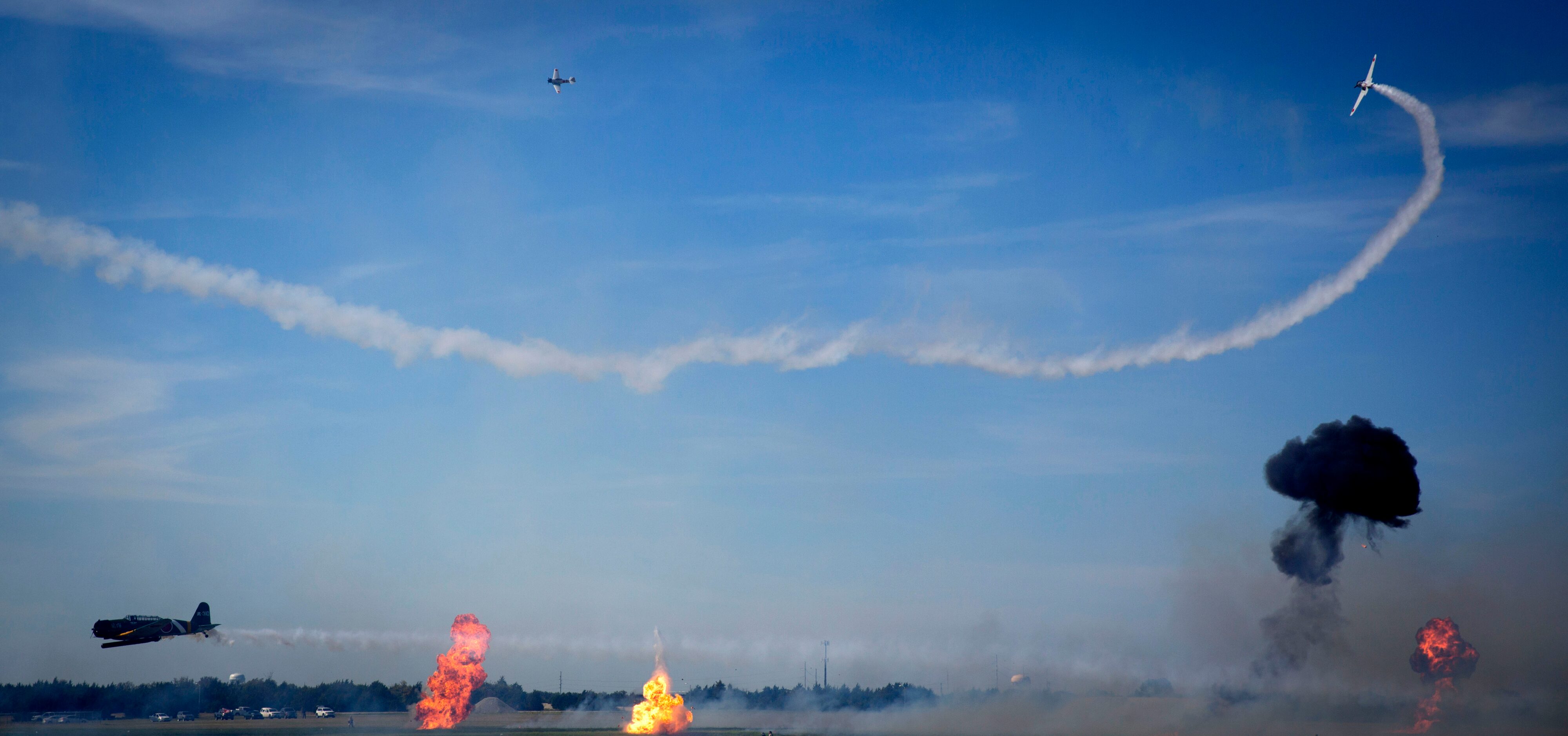 Pyrotechnics explode during a re-enactment of Pearl Harbor at the Commemorative Air Force...