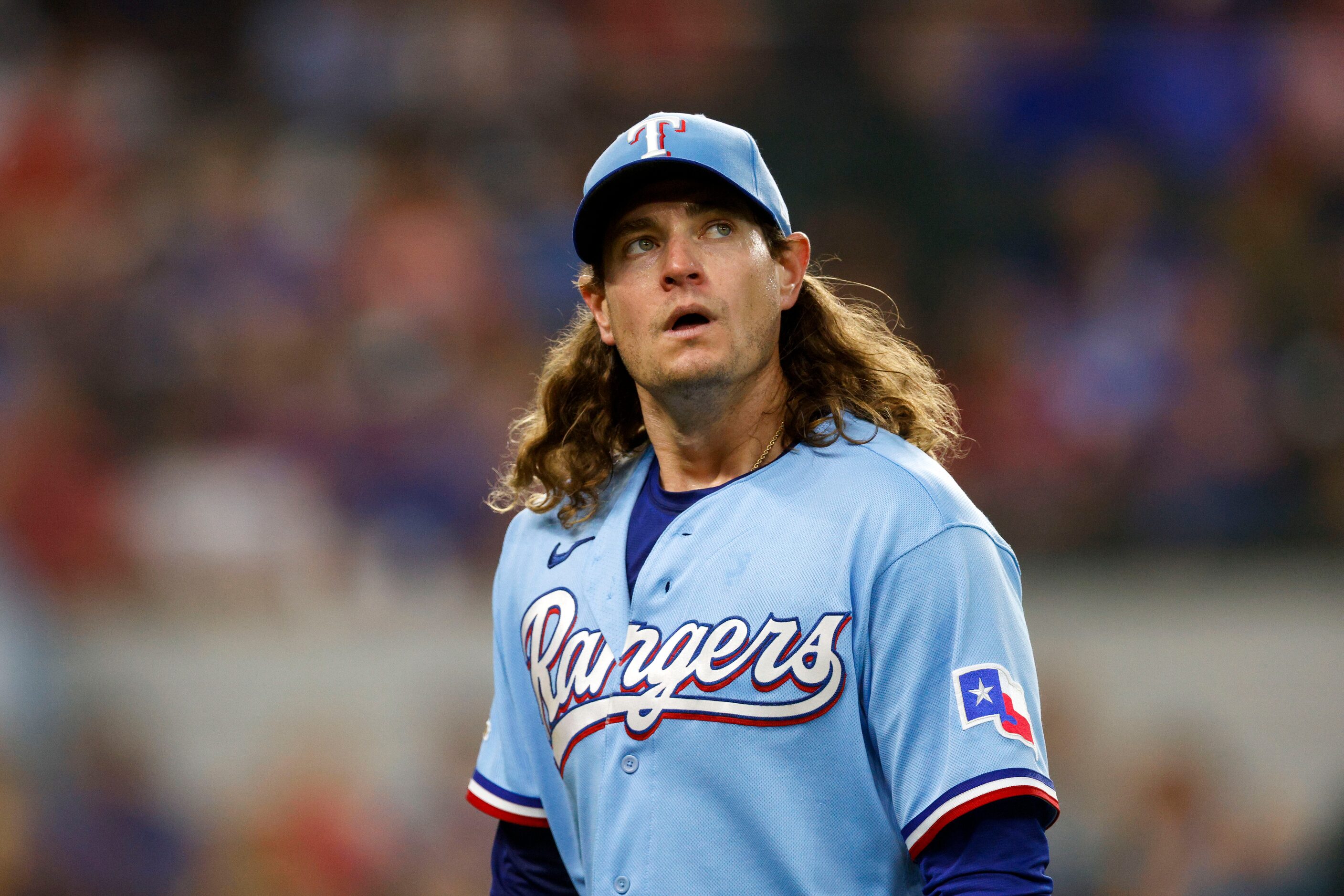 Texas Rangers relief pitcher Garrett Richards (43) walks off the field after giving up three...