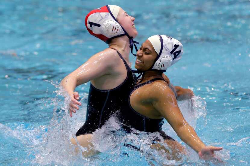 Flower Mound's Natalie Stearns (1) and Varsha Kolli (14) chest bump in the water to...