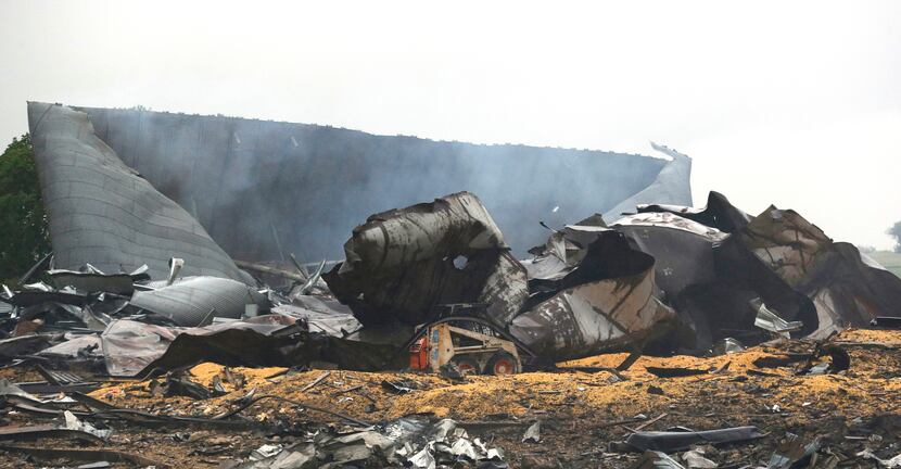 A small front-end loader sits in the wreckage of the West Fertilizer Co., which caught fire...