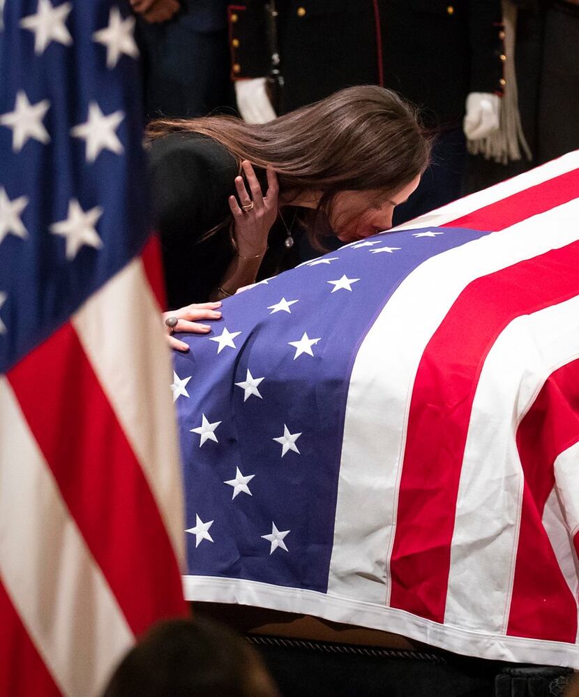 Barbara Pierce Bush kisses the flag-draped casket of her grandfather President George H.W....