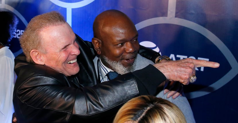 Former Dallas Cowboys football player Emmitt Smith (right) and former director of operations...