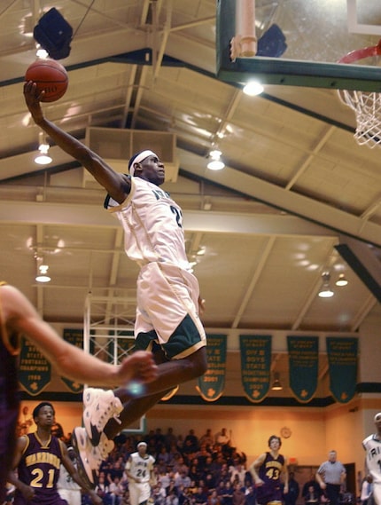 LeBron James dunks during a game against Walsh Jesuit in Akron in 2003.