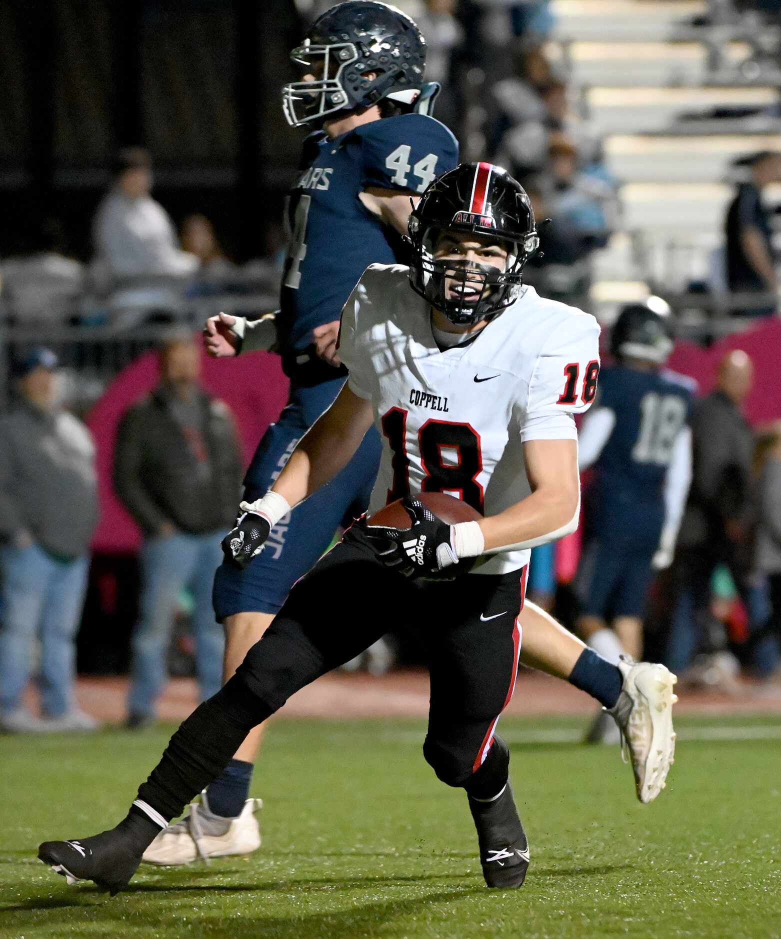 Coppell's free safety Charlie Barker (18) celebrates his touchdown catch in front of Flower...