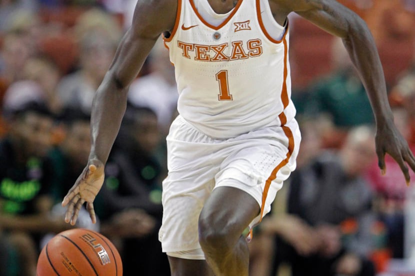 FILE - In this March 4, 2017, file photo, Texas guard Andrew Jones dribbles the ball during...