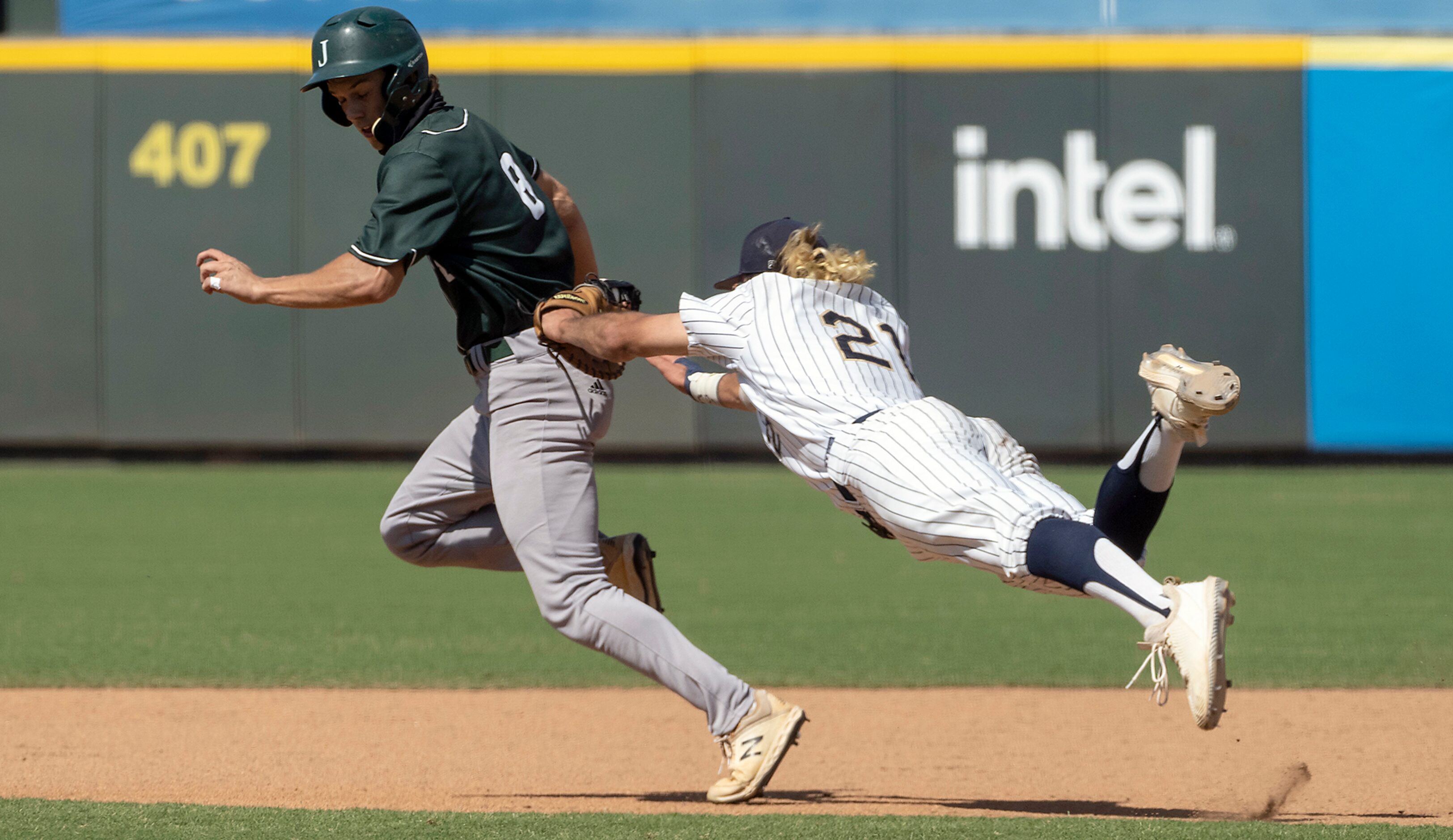 Keller Gray Rowlett, (21), dives to tag out Houston Strake Jesuit, Gabe Gruenewald, (8),...