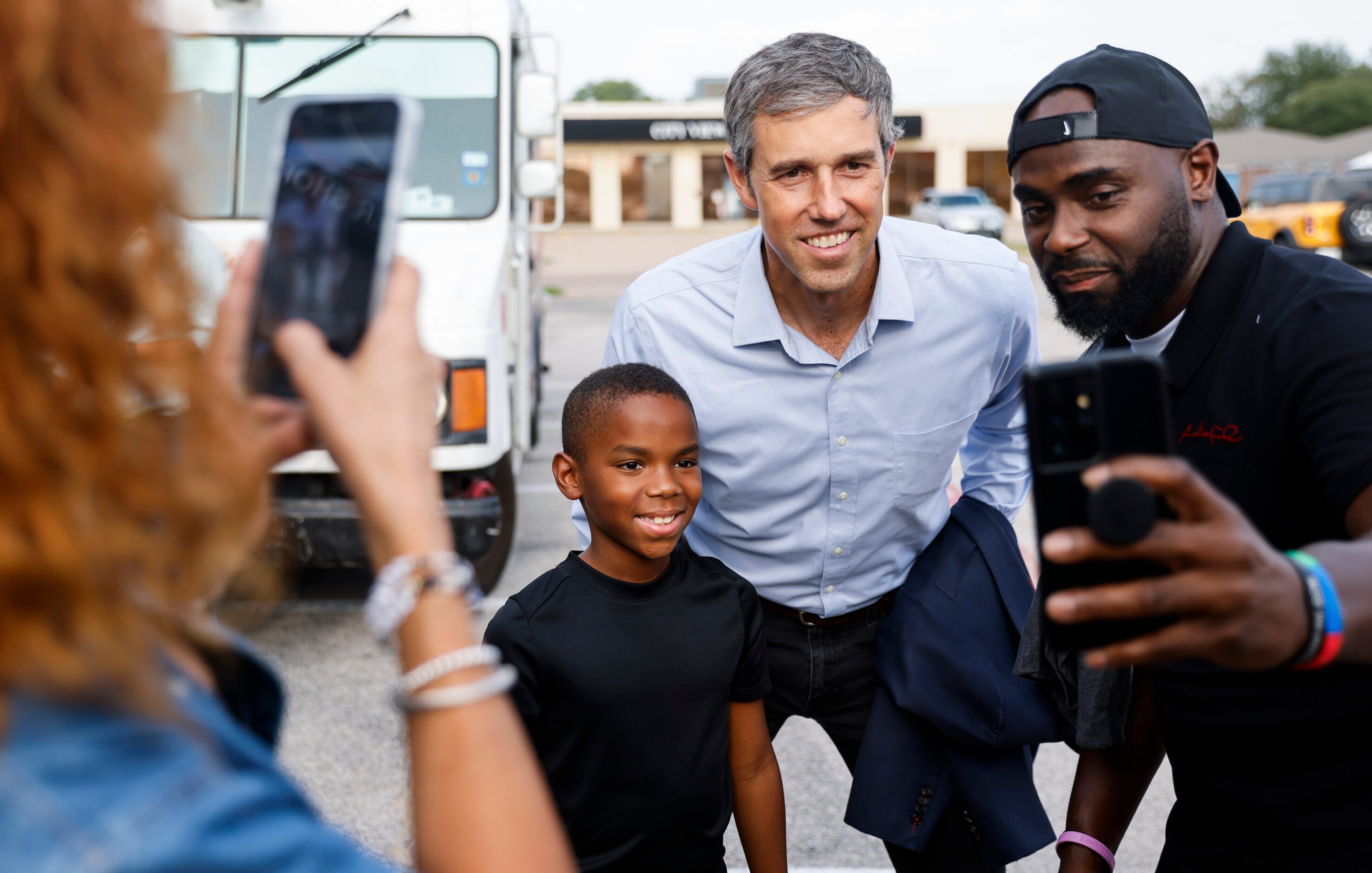 Texas Governor candidate Beto O'Rourke, center, takes a photo with one of the owners of...