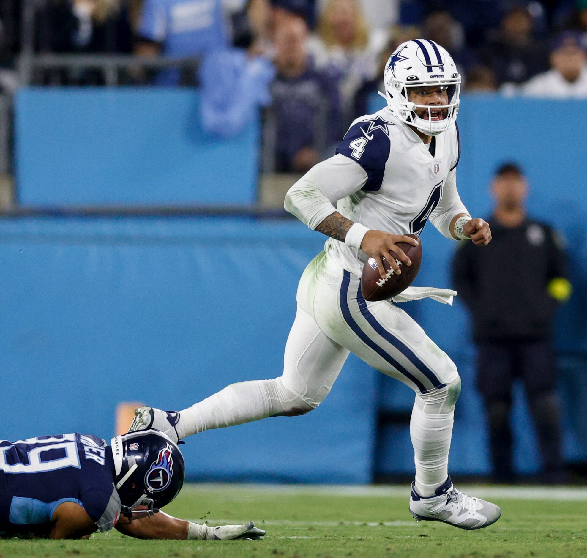 Dallas Cowboys quarterback Dak Prescott (4) evades pressure from Tennessee Titans linebacker...