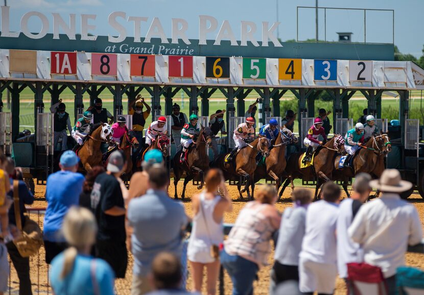 Fans look on during the start of a Claiming race at Lone Star Park in Grand Prairie, Sunday,...