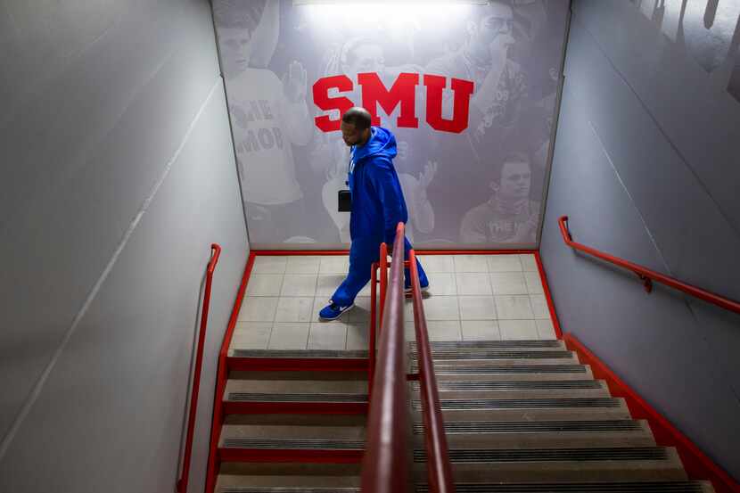 Travis Mays, head coach of Southern Methodist University women's basketball, walks down a...