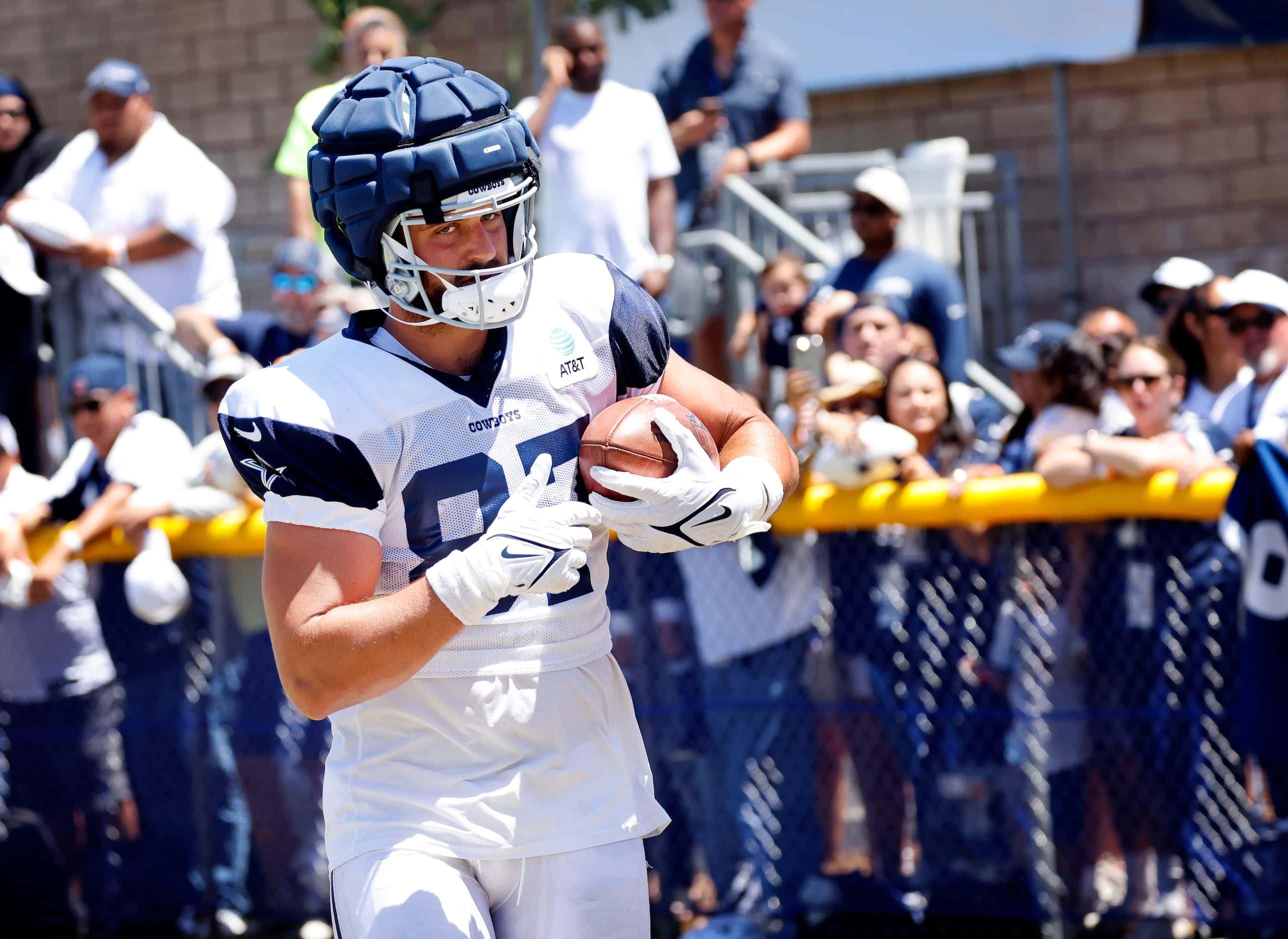 Dallas Cowboys tight end Jake Ferguson (87) catches a pass off the throwing machine...