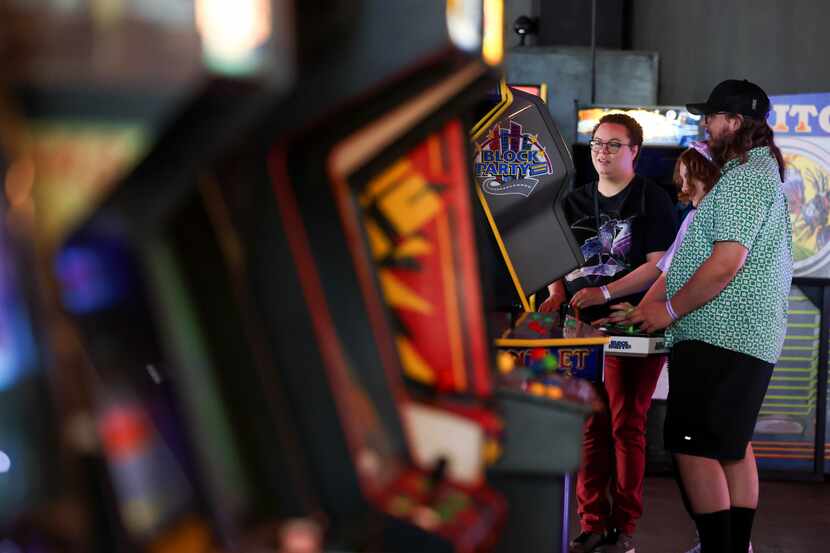 Adrianna Macey (left), Morrigan Macey, 12, and Alex Macey (right) play a game together at...