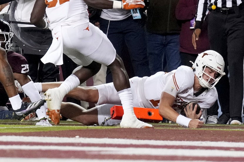 Texas quarterback Arch Manning (16) dives over the pylon for a touchdown against Texas A&M...