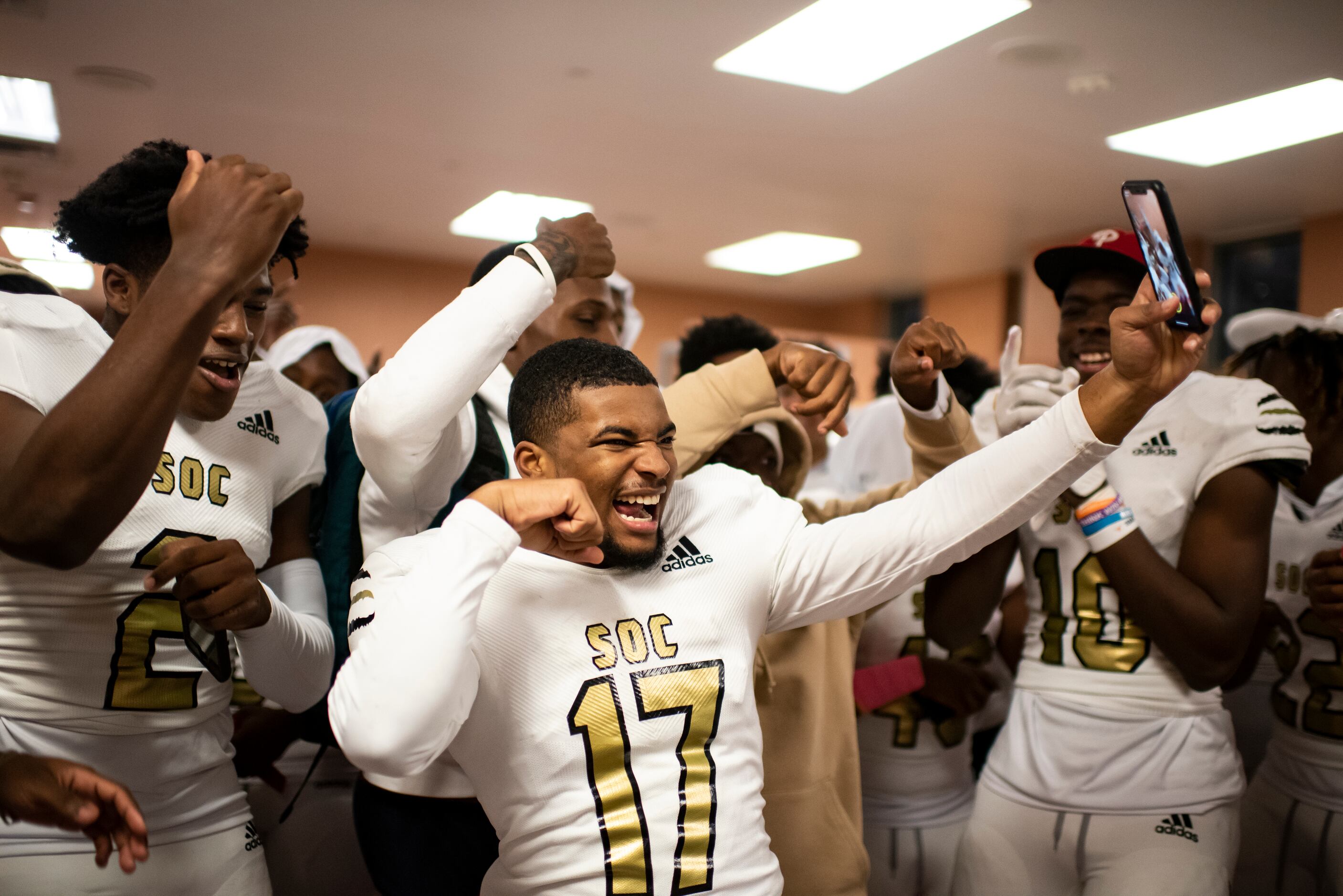 South Oak Cliff sophomore Rickey Evans (17) celebrates with his teammates during halftime of...