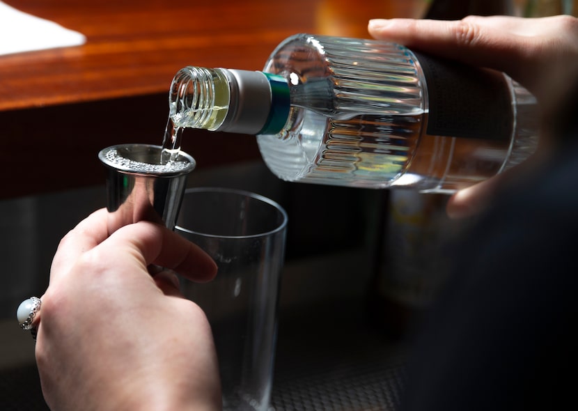 Bar manager Madeline Russell makes a Shochu-yuzu cocktail at Salaryman in Dallas. 