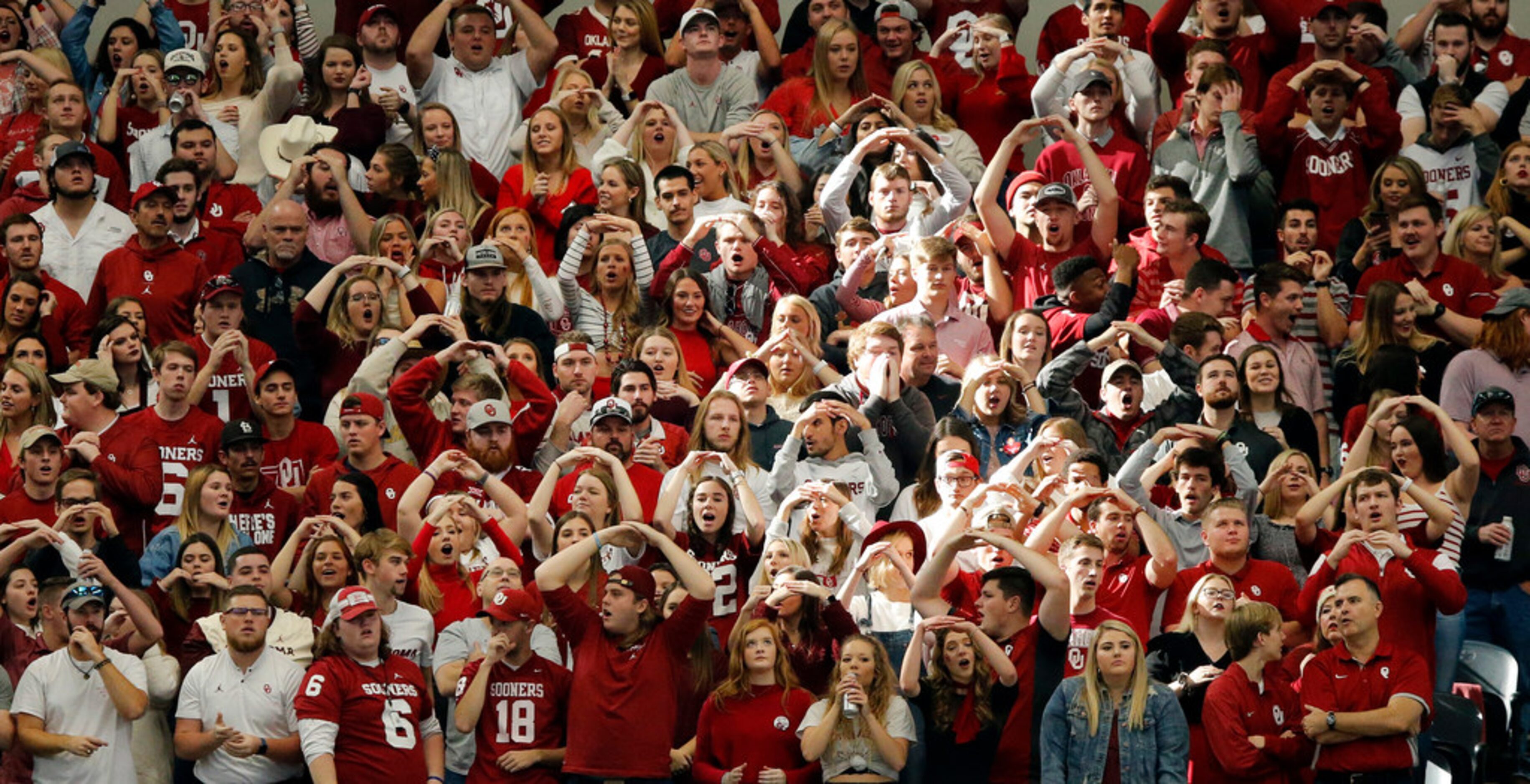 Oklahoma Sooners fans cheer their team during the Big 12 Championship game with the Baylor...