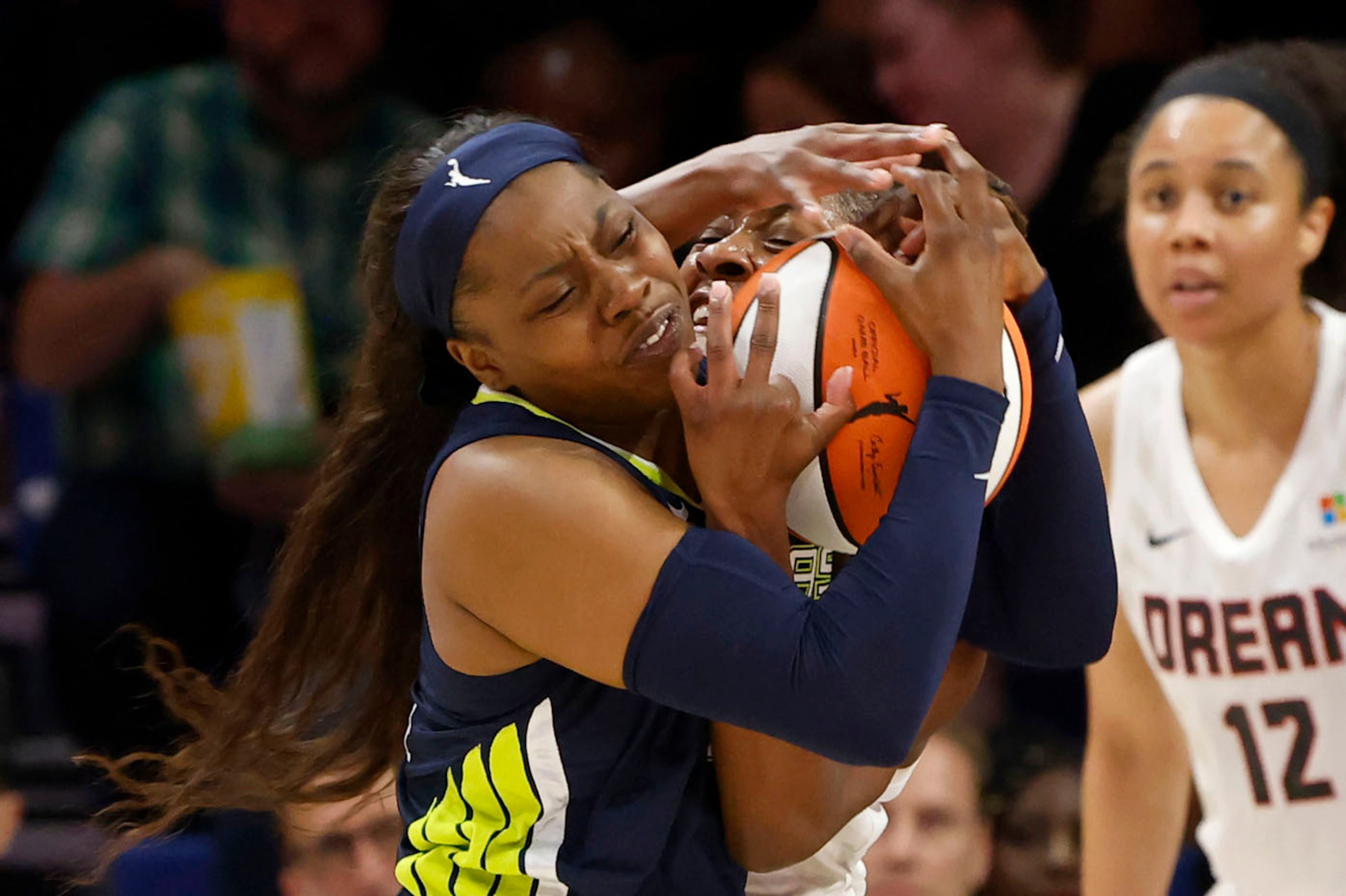 Dallas Wings guard Arike Ogunbowale (24) left, and Atlanta Dream guard Aari McDonald (2)...