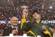 Former Green Bay Packers head coach Mike McCarthy admired the Lombardi Trophy as Terry...