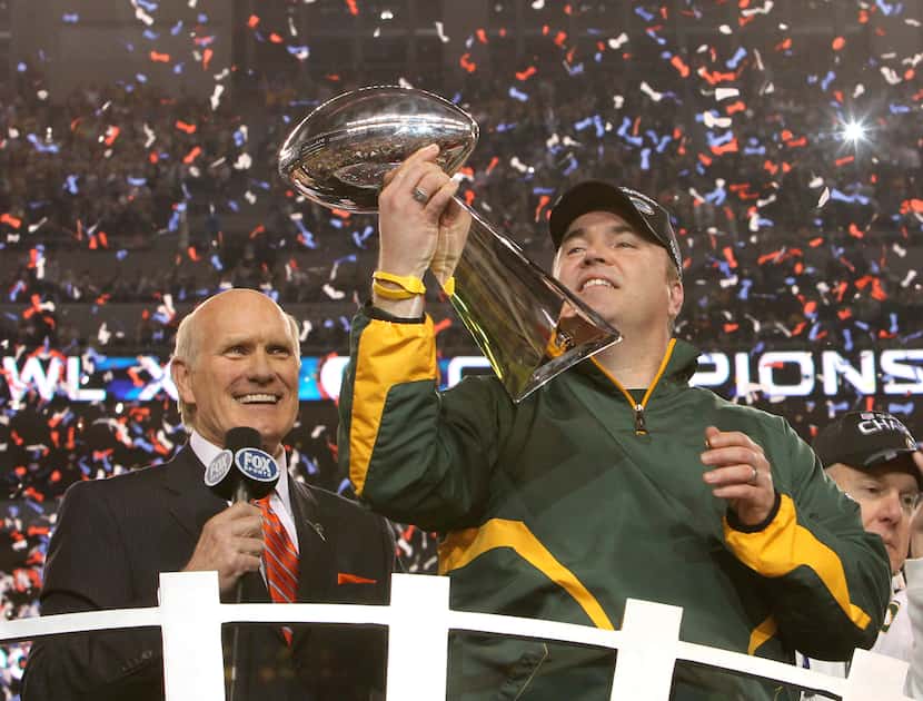 Then-Green Bay Packers head coach Mike McCarthy, now the Dallas Cowboys' coach, hoisted the...