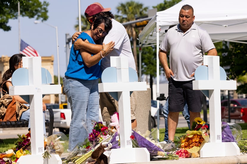 Dora Mendoza (left), grandmother to ten-year-old victim Amerie Jo Garza, hugs family friend...