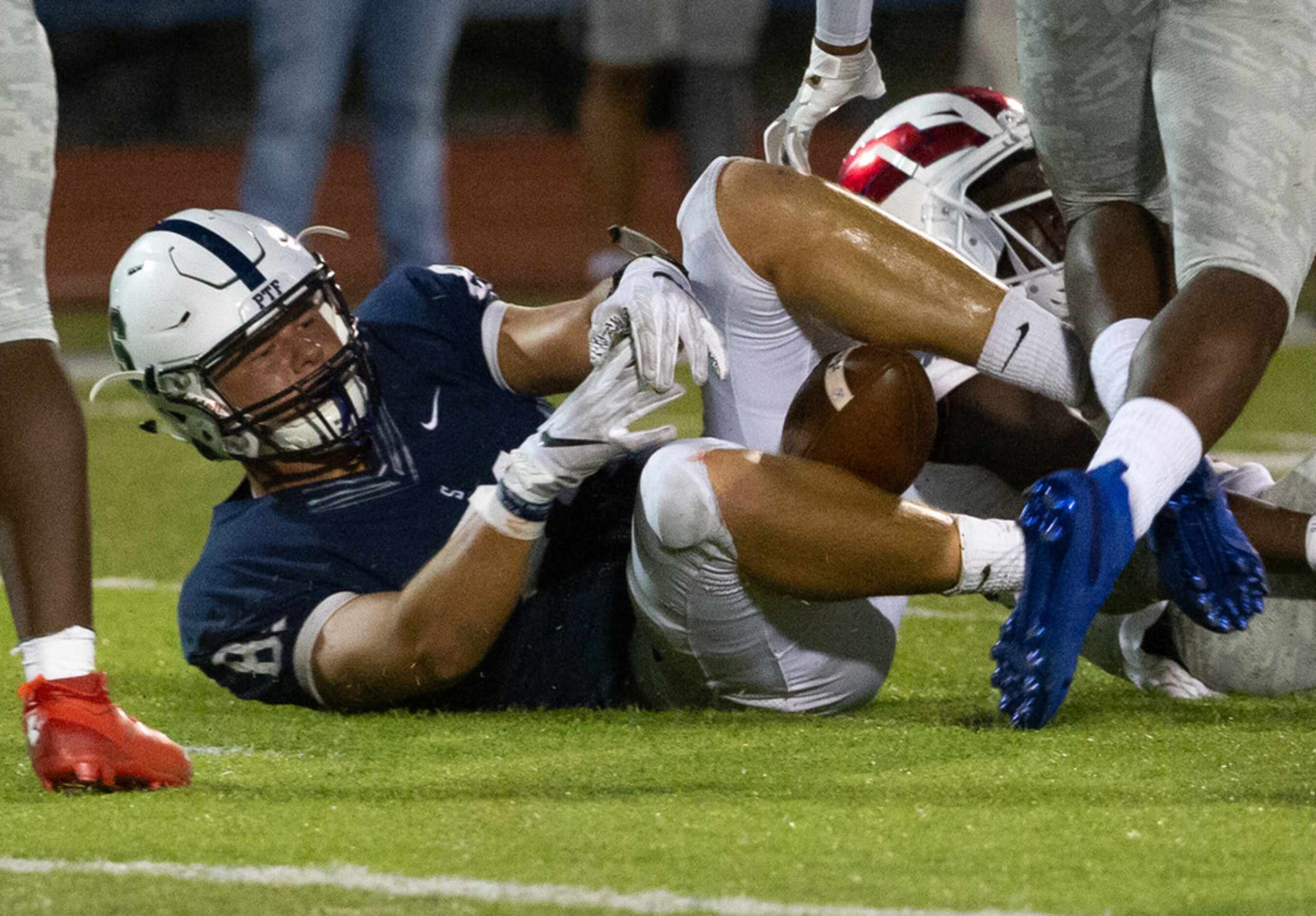 All Saints' Episcopal tight end Mitchell Bothwell (81) gets sacked during a play in a game...