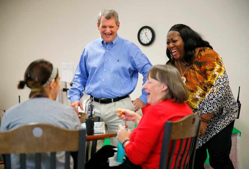 Incoming Allen ISD Superintendent Scott Niven (standing, left) laughs with teachers and...