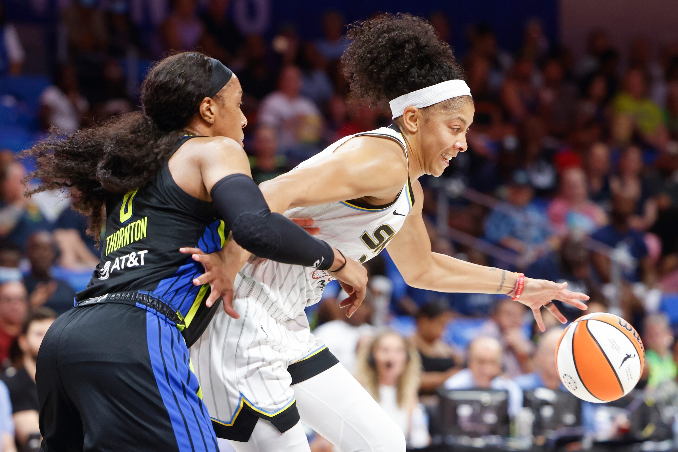 Chicago Sky forward Candace Parker, right, dribbles past Dallas Wings forward Kayla Thornton...