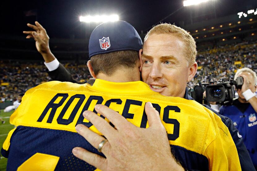 Dallas Cowboys head coach Jason Garrett (right) hugs Green Bay Packers quarterback Aaron...