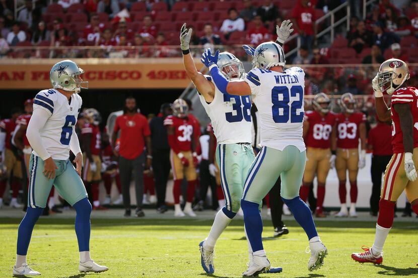 Dallas Cowboys strong safety Jeff Heath (38) celebrates with tight end Jason Witten (82)...