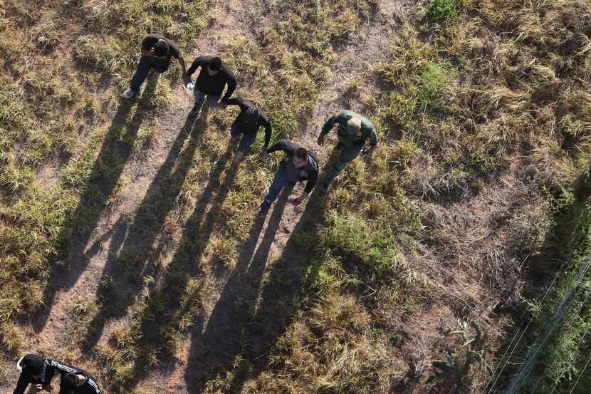  U.S. Border Patrol agents with the help of helicopter pilots from the U.S. Office of Air...