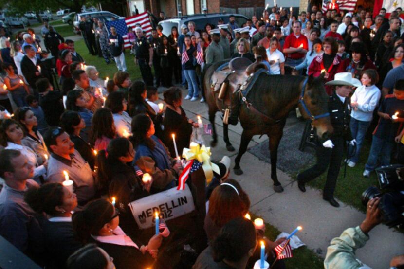 C.M. Grady, a Fort Worth mounted patrol officer, led her riderless horse through the crowd...
