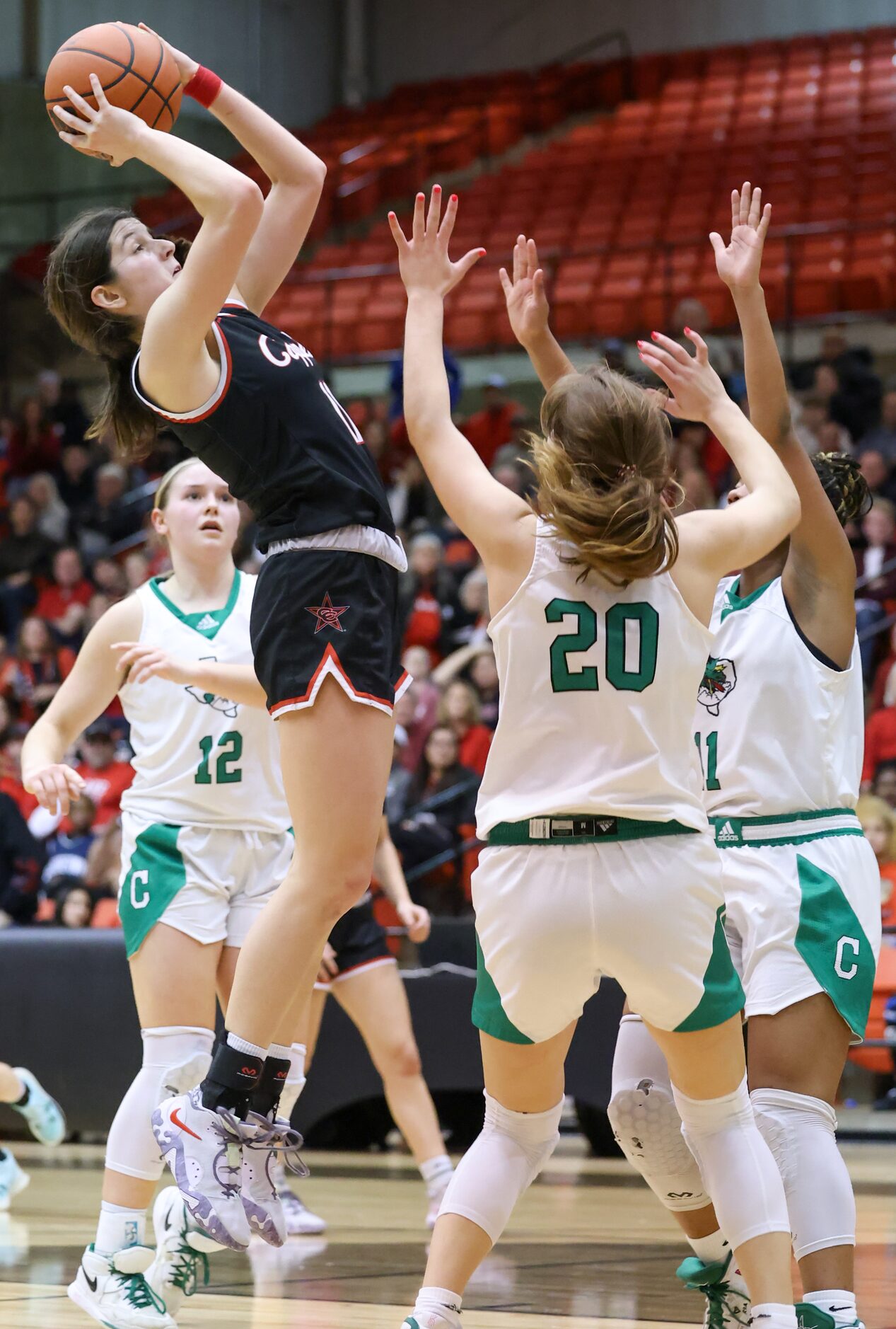 Coppell senior guard Waverly Hassman (11) jumps for an attempted two-point shot over...