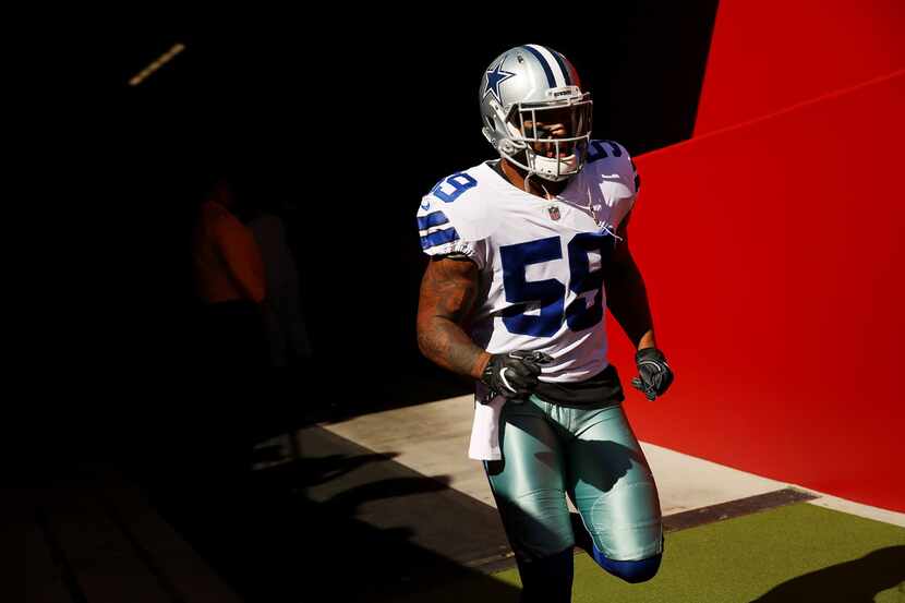 FILE - Cowboys linebacker Anthony Hitchens (59) runs onto the field before a game between...