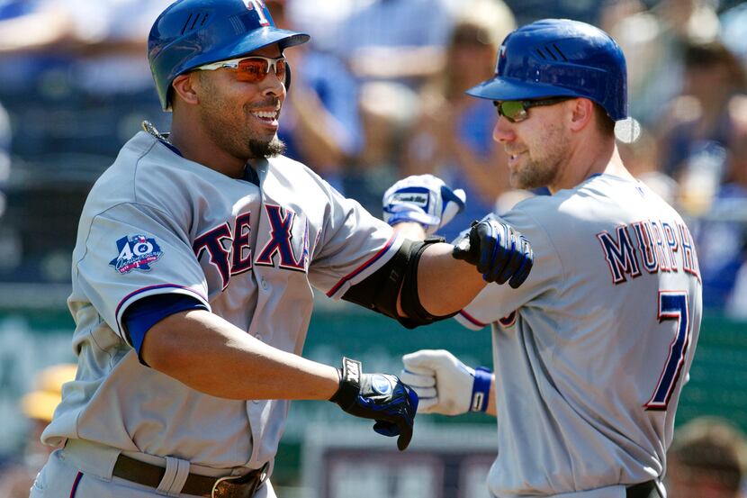 Texas Rangers' Nelson Cruz, left, is congratulated by David Murphy (7) after his solo home...