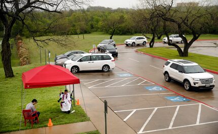 Under a light mist, the Rev. Michael Picard, a Regnum Christi priest, blessed a parishioner...