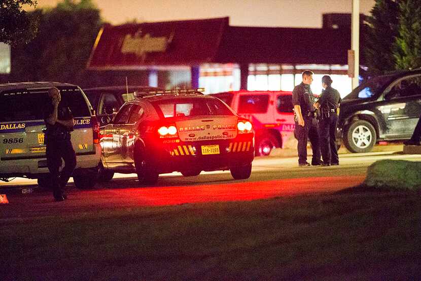  Police gather at the intersection of Interstate 45 and E Palestine Street, where police...