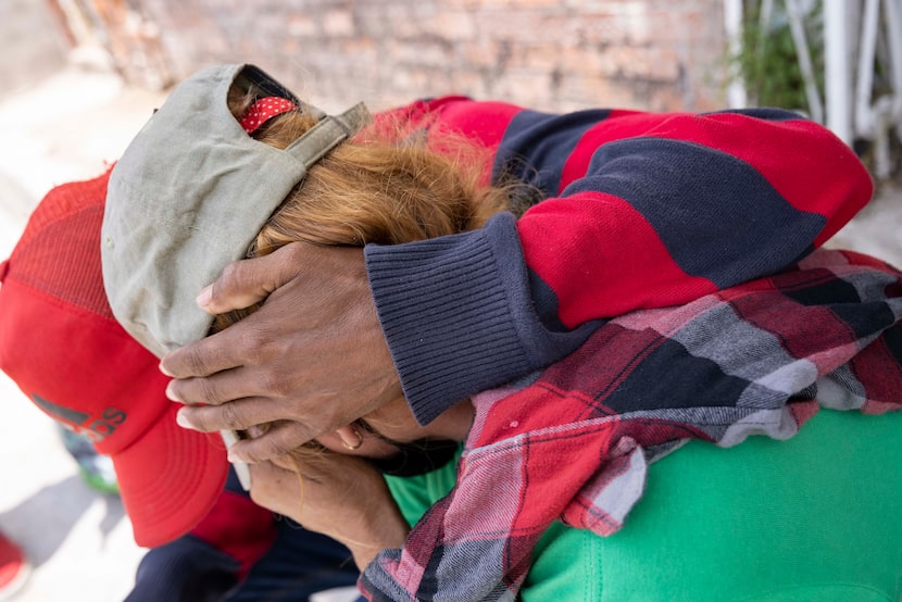 A couple from Honduras comfort each other after the wife became emotional recounting the...