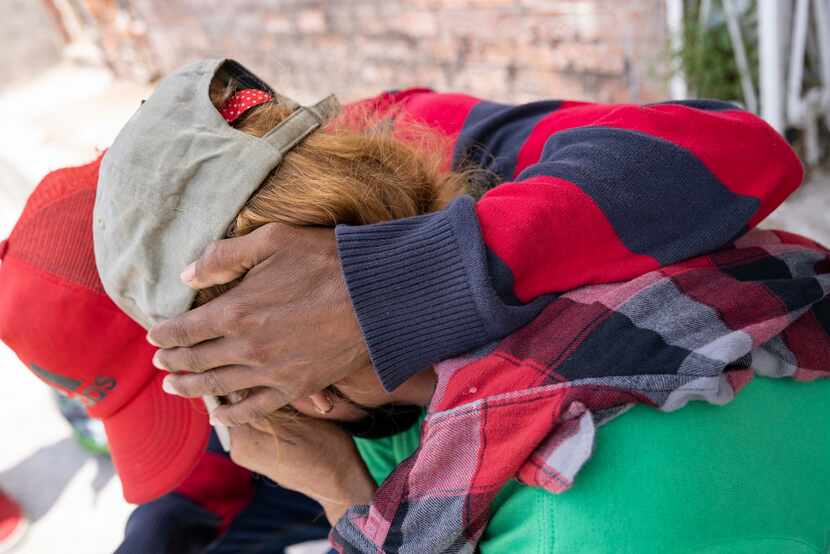 A couple from Honduras comfort each other after the wife became emotional recounting the...