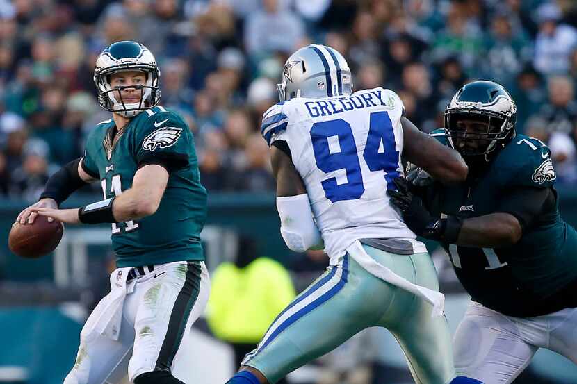 Philadelphia Eagles quarterback Carson Wentz (11) looks up to pass the ball as Dallas...