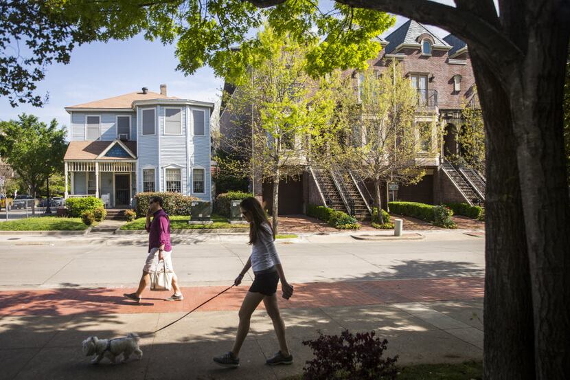 Pedestrians pass the home of Ruth Sanders in Uptown on Saturday, March 26, 2016, in Dallas....