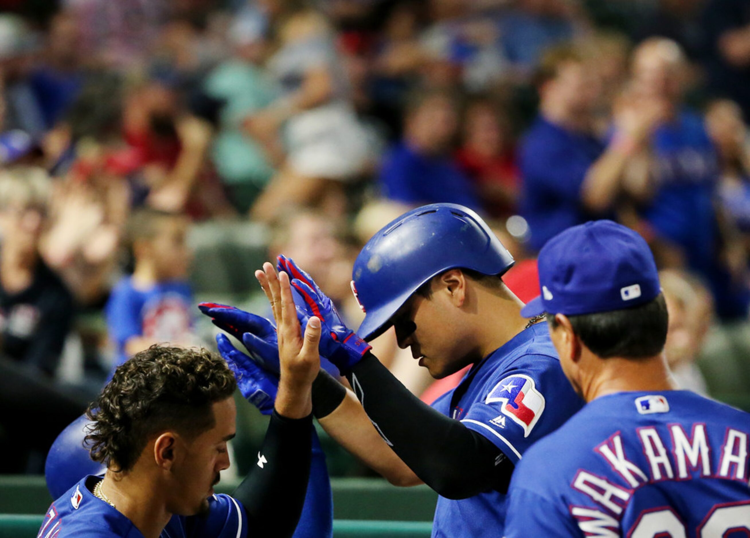 Texas Rangers designated hitter Shin-Soo Choo (17) celebrates with teammates after third...