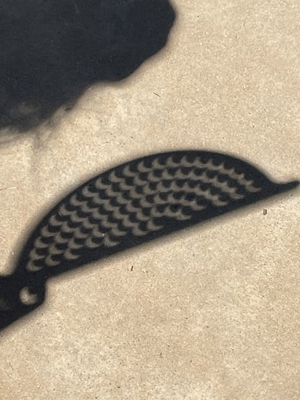 A colander is used to indirectly view a partial solar eclipse.