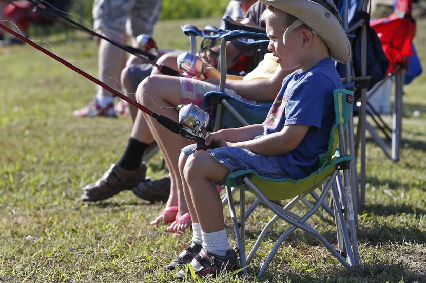 David Helm, 3, of Murphy, waits patiently for some action on his fishing line at Brockdale...