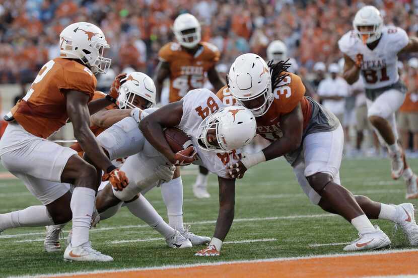 Texas wide receiver Lil'Jordan Humphrey (84) is hit, after making a catch, by linebacker...