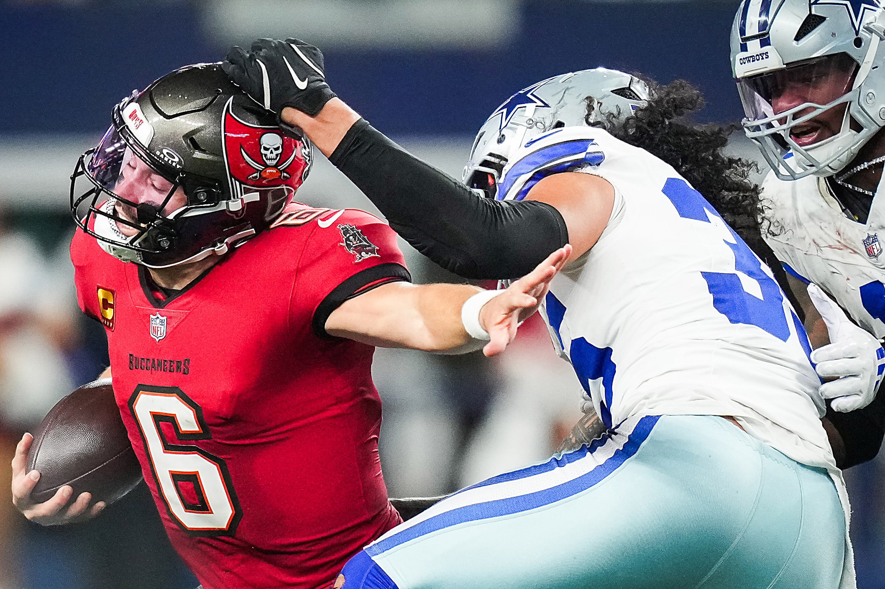 Tampa Bay Buccaneers quarterback Baker Mayfield (6) is chased from the pocket by Dallas...