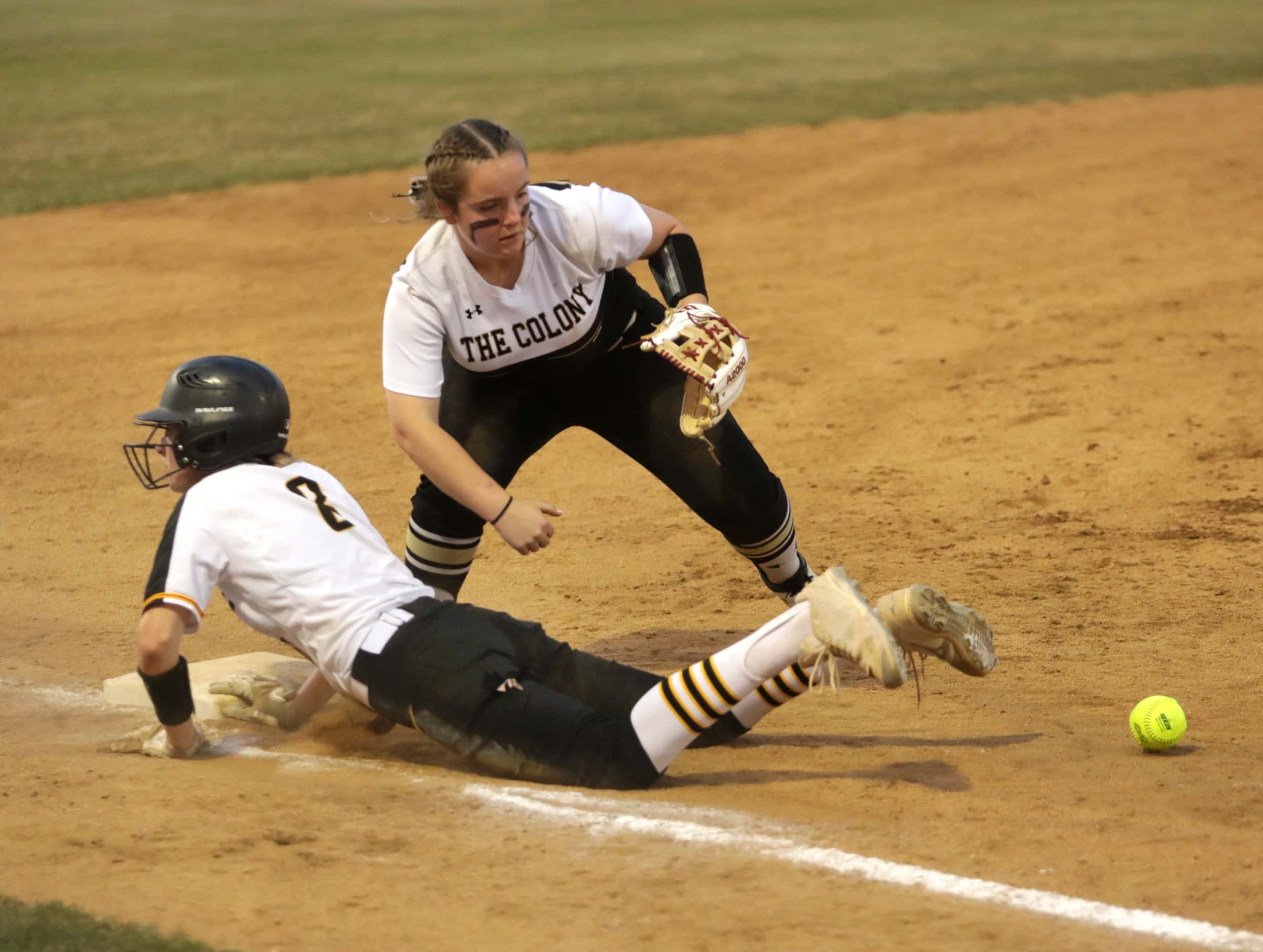 Frisco Memorial High School #8, Natalie Gowan, dives back into third base as The Colony High...