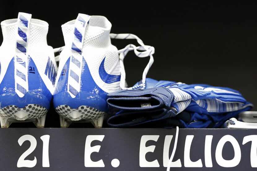 Football cleats and gloves sit inside a locker of Cowboys' first-round pick Ezekiel Elliott...
