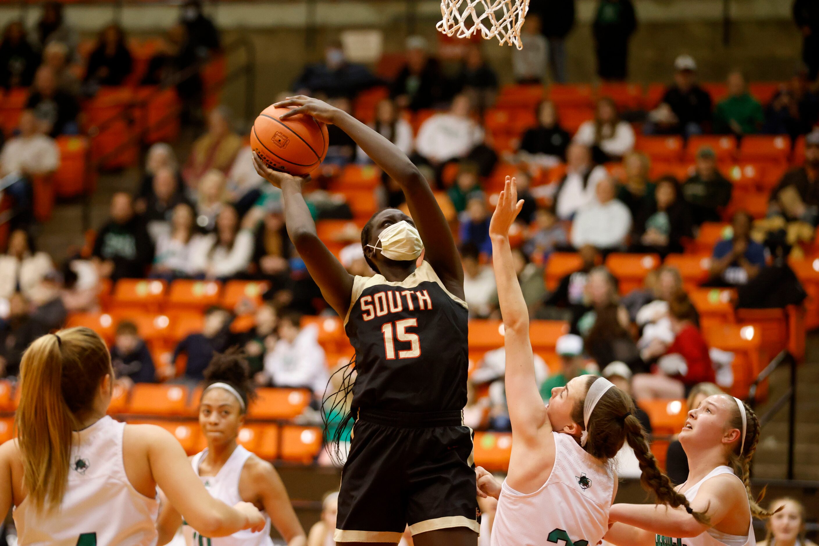 South Grand Prairie player Adhel Tac (15) shoot over Southlake Carroll defender Kylie...