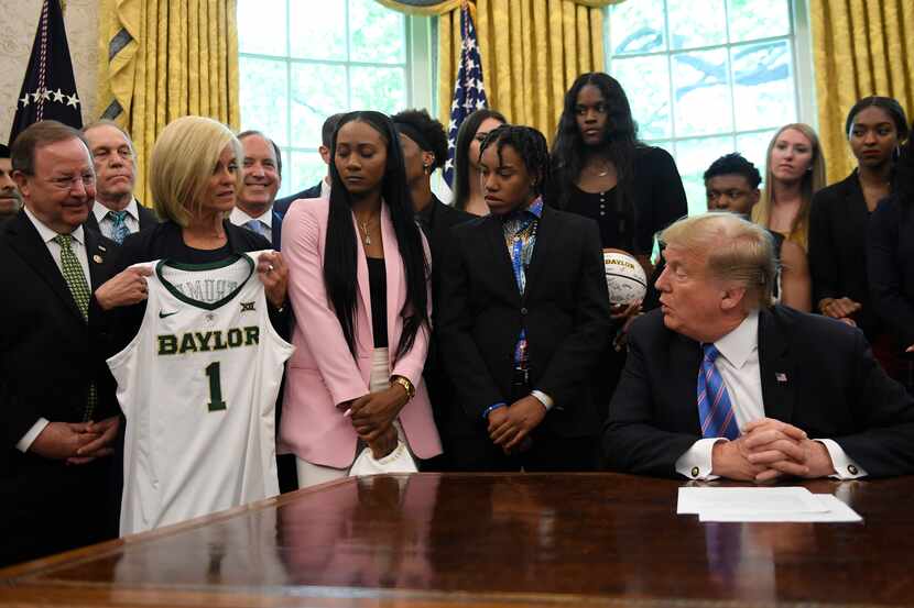 Baylor women's basketball head coach Kim Mulkey, third from left, presents a jersey to...