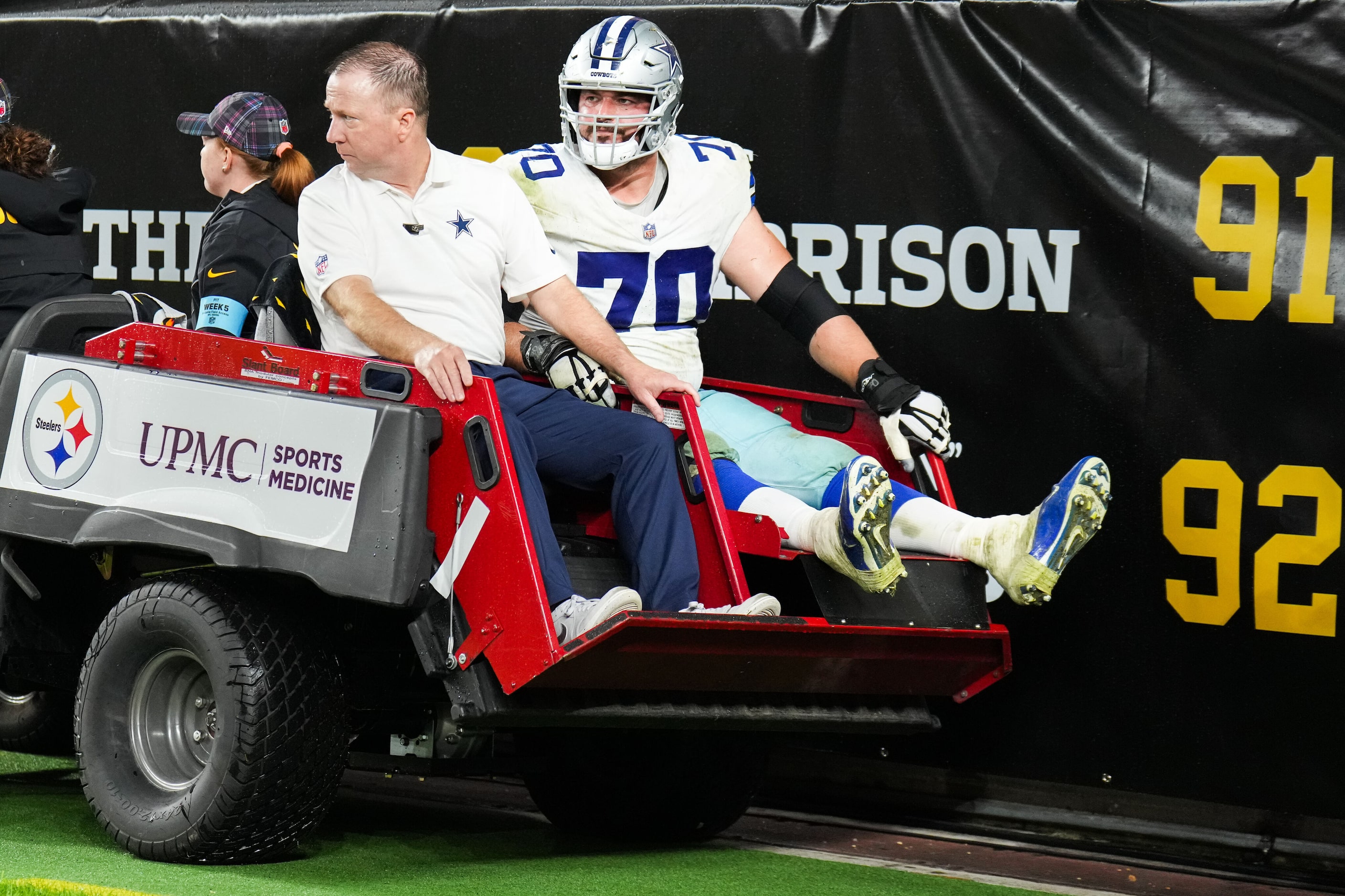 Dallas Cowboys guard Zack Martin (70) leaves the field on a cart during the second half of...